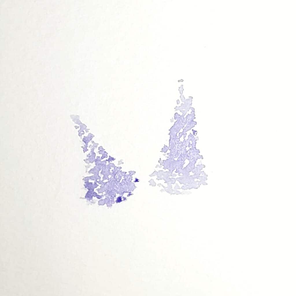 There is an image of two lilac flowers. Both lilacs are painted in a long triangle shape. This is the second step in the how to paint lilac tutorial.